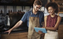 Man and woman with iPad in small business