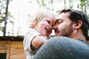 father holding young daughter