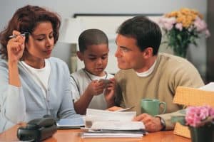 Couple with son reviewing paperwork