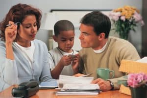 Couple with son reviewing paperwork