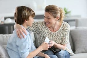 Mother giving money to adolescent for reward