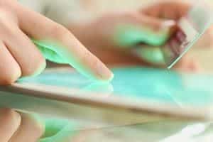 shopper using tablet and credit card