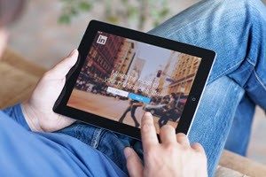 Man using LinkedIn on iPad