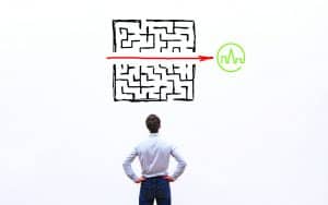 a man looking at maze with an arrow in the middle pointing to our logo