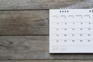 Daily calendar sitting on wooden surface
