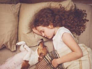 girl and dog sleeping