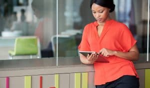 Woman using a tablet in an open office space