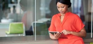 Woman using a tablet in an open office space