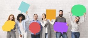 Diverse group of people holding up multi-colored thought bubbles