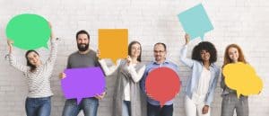 Diverse group of people holding up multi-colored thought bubbles