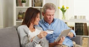 senior couple making a purchase on tablet