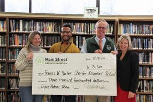 Group of people holding a large donation check for $3,500 to Francis W. Parker Charter School