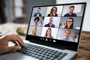 image of laptop screen with several people participating in a virtual meeting
