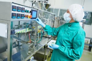 pharmaceutical factory woman worker operating production line at pharmacy industry manufacture factory