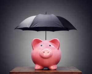 Financial insurance or protection piggy bank with umbrella