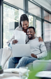 Shot of a young couple going through emergency savings paperwork at home.