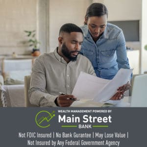 African American man and woman looking over a bank statement together