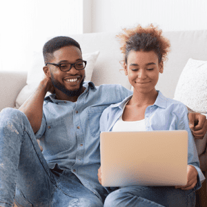 Man and woman looking at a laptop screen together