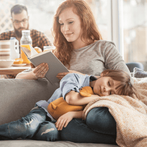 Mother and young son sitting together on a couch