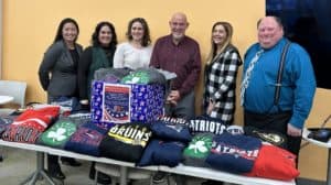 MSB employees pose with Mark Vital, founder of Sweats for Vets.