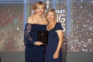 Ellen Dorian, President & COO of Main Street Bank poses with Roxanne Emmerich who holds the award that Main street Bank one.