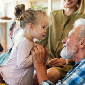 Cheerful multi-generation family having fun while spending time together at home. People happiness concept. Related to family preparing trust account for future.