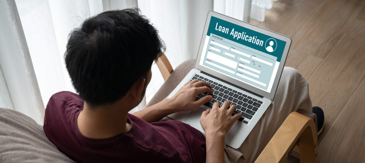 Young man filling out online loan application